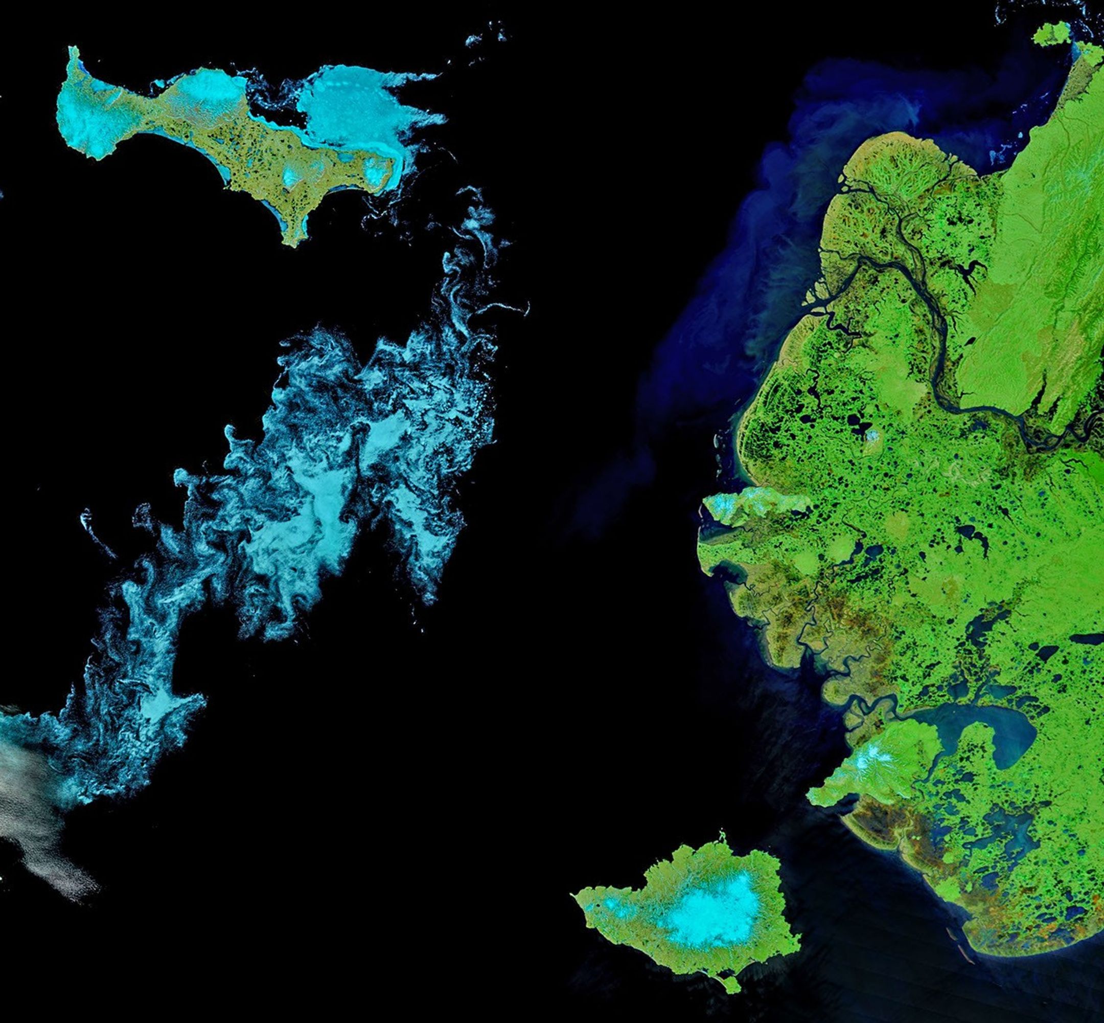 A false-color satellite image shows two large islands west of mainland Alaska. Sea ice fragments appear light blue and form swirling patterns in the ocean. The land appears mostly light green, interrupted by many small ponds and a large river delta.