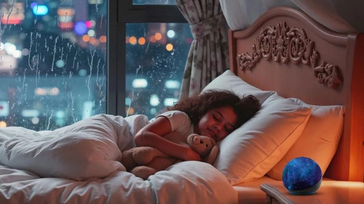 A girl sleeps in bed with a stuffed animal and an Amazon Echo speaker on her bedside table.