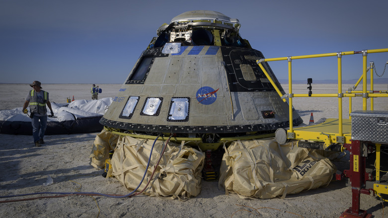 A Boeing Starliner with its airbags deployed after landing in White Sands, New Mexico