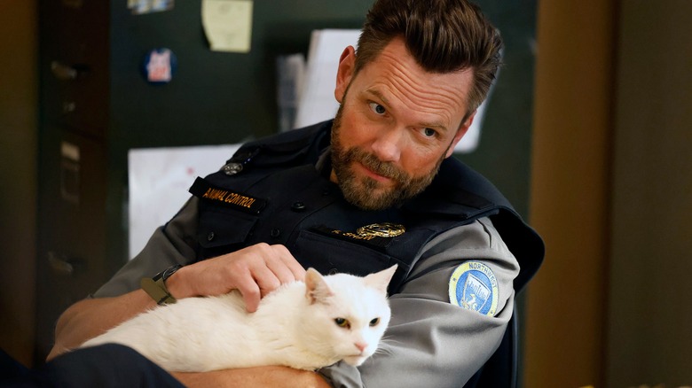 Frank petting a white cat