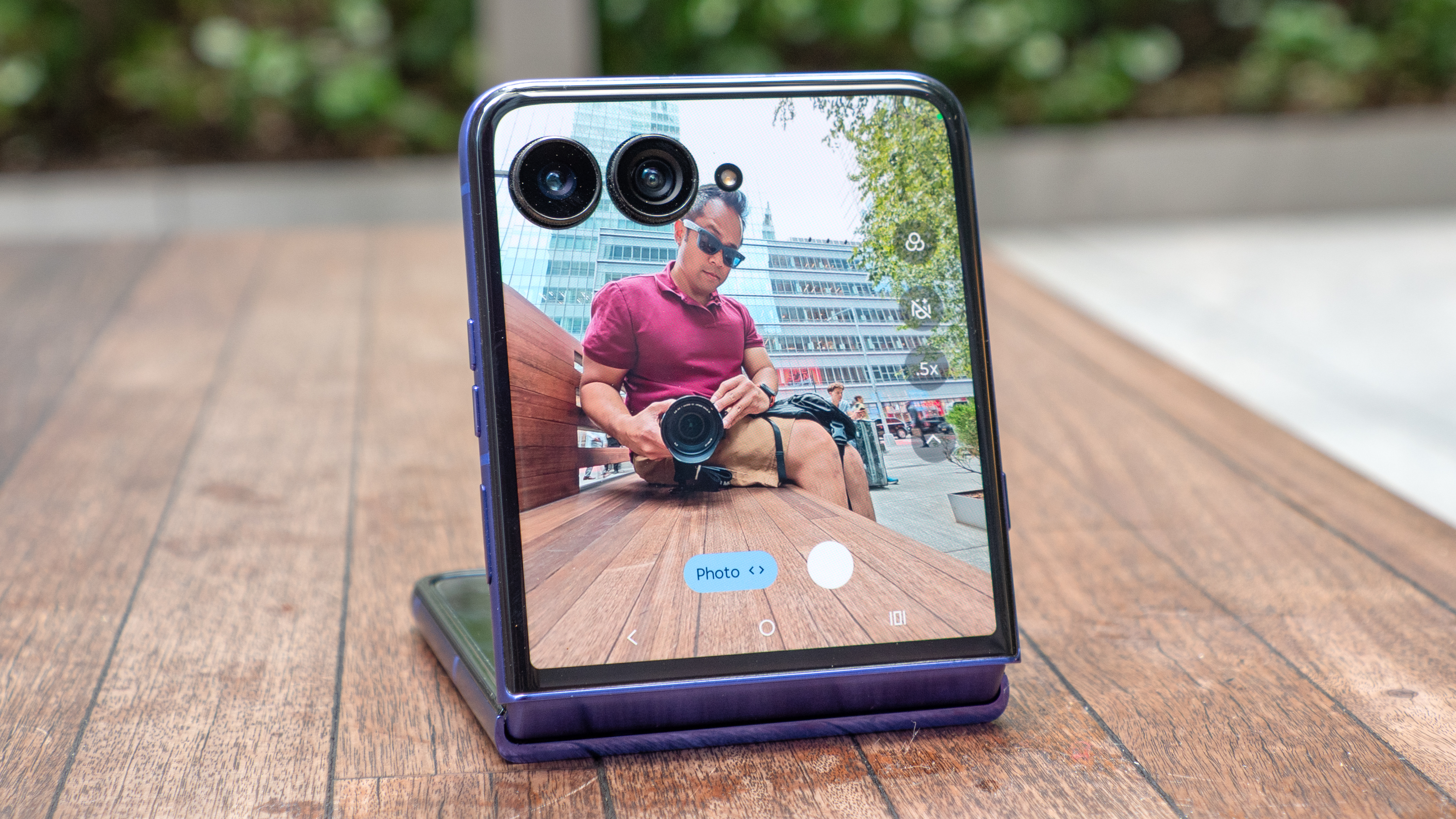 Motorola Razr Ultra 2026 in flex mode using outer screen for a photo.