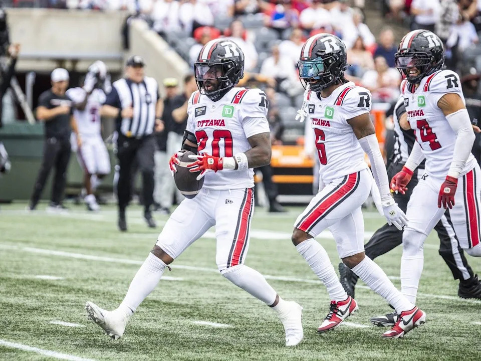 Redblacks safety Alonzo Addae celebrates after making an interception during the first half of the game against the Argonauts.