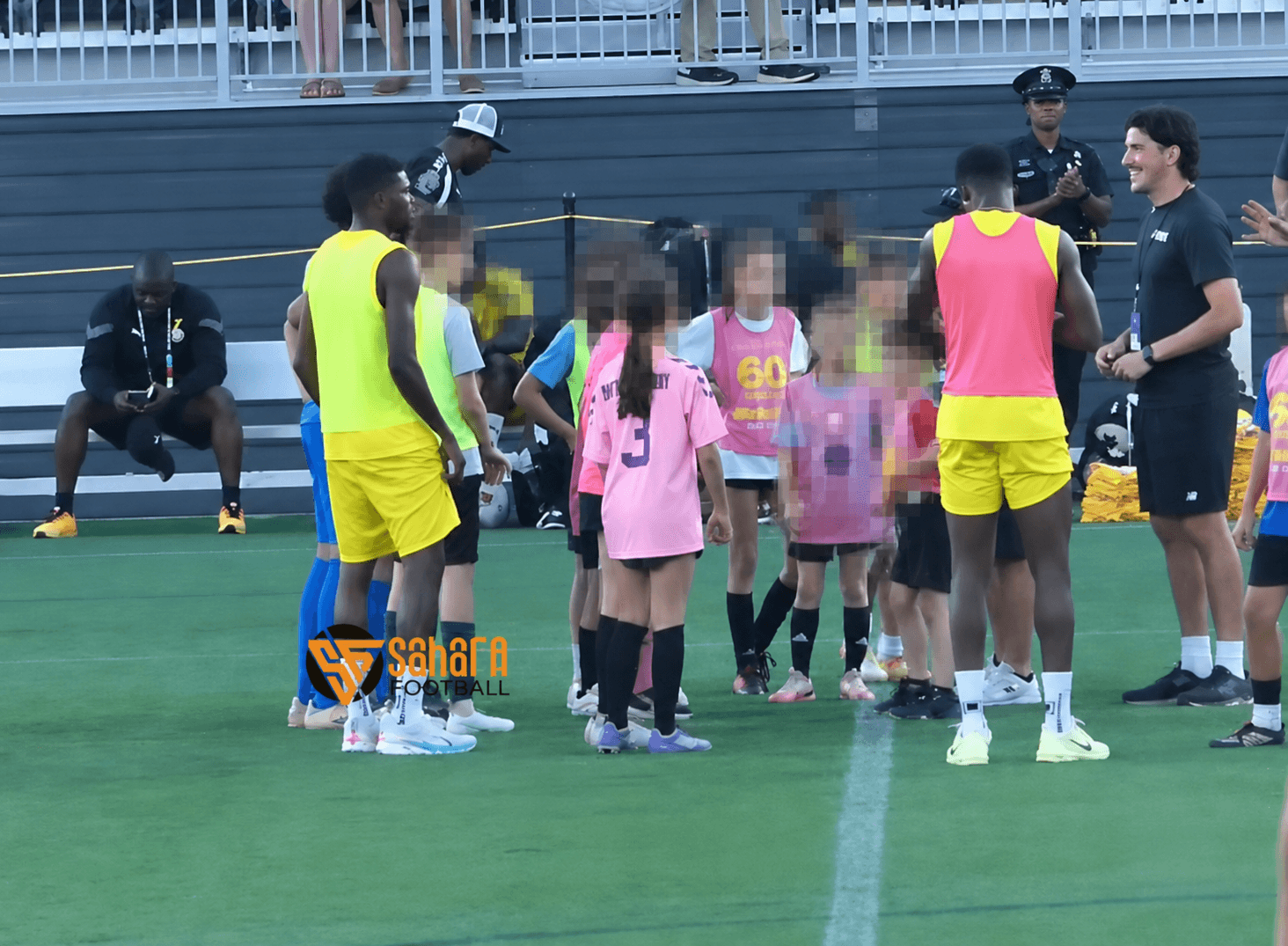 A group of child soccer players gather