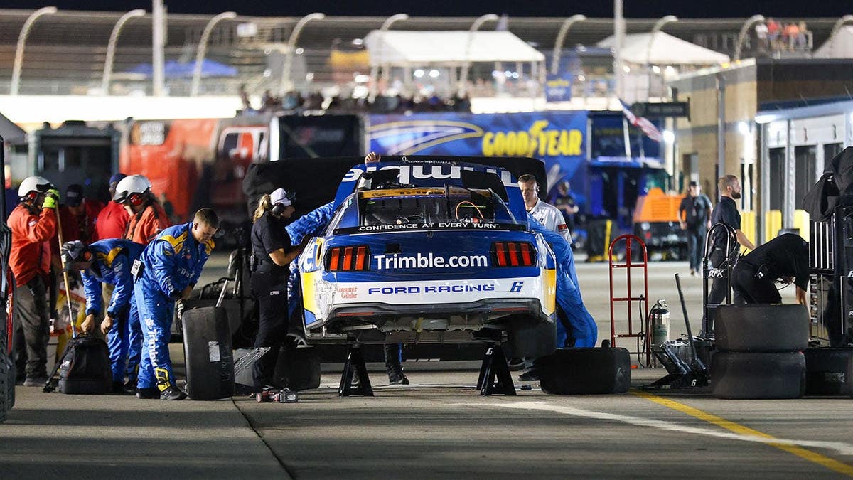 Brad Keselowski's race car being worked on after a crash at Nashville Superspeedway
