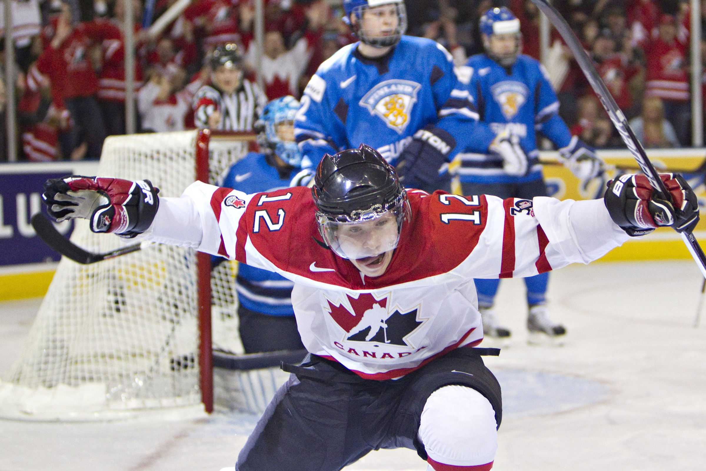 Brendan Gallagher celebrates a goal in a Team Canada jersey while sticking his tongue out.