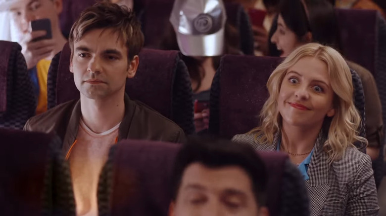 Cary looking serious while Brooke smiles on plane