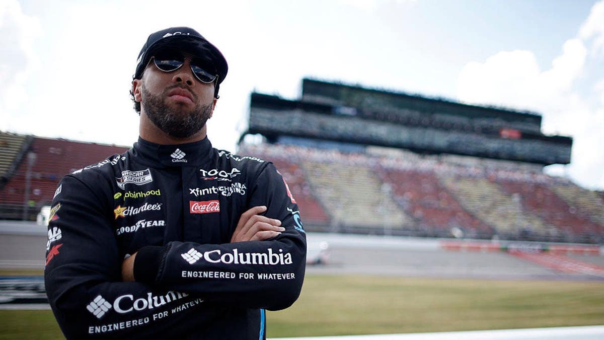 Bubba Wallace standing on the grid at Michigan International Speedway.