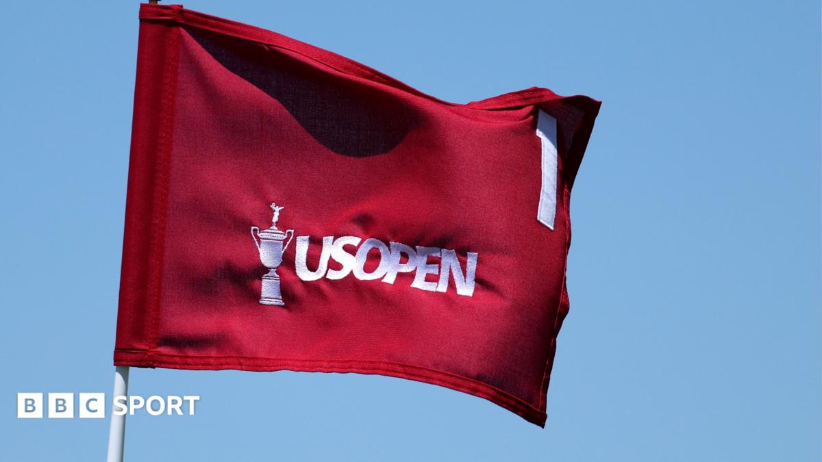 A red flag with an image of the US Open trophy, the words US Open and the number one on it, all in white.
