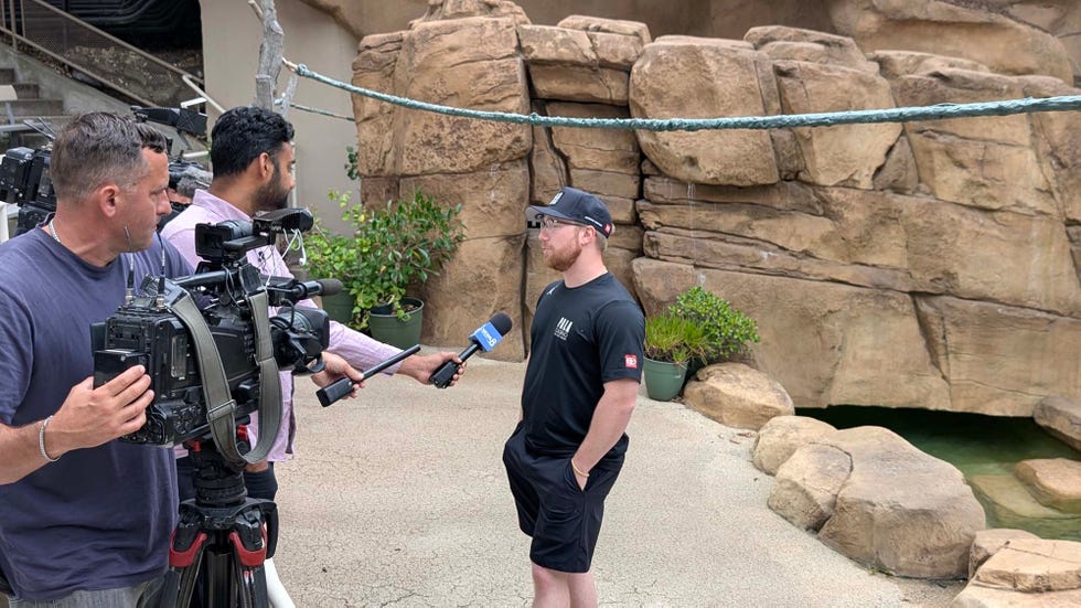 interview setup with a person speaking to a journalist surrounded by cameras interview setup with a person speaking to a journalist surrounded by cameras