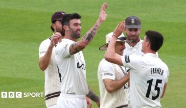 Matt Fisher is congratulated after bowling Toby Albert