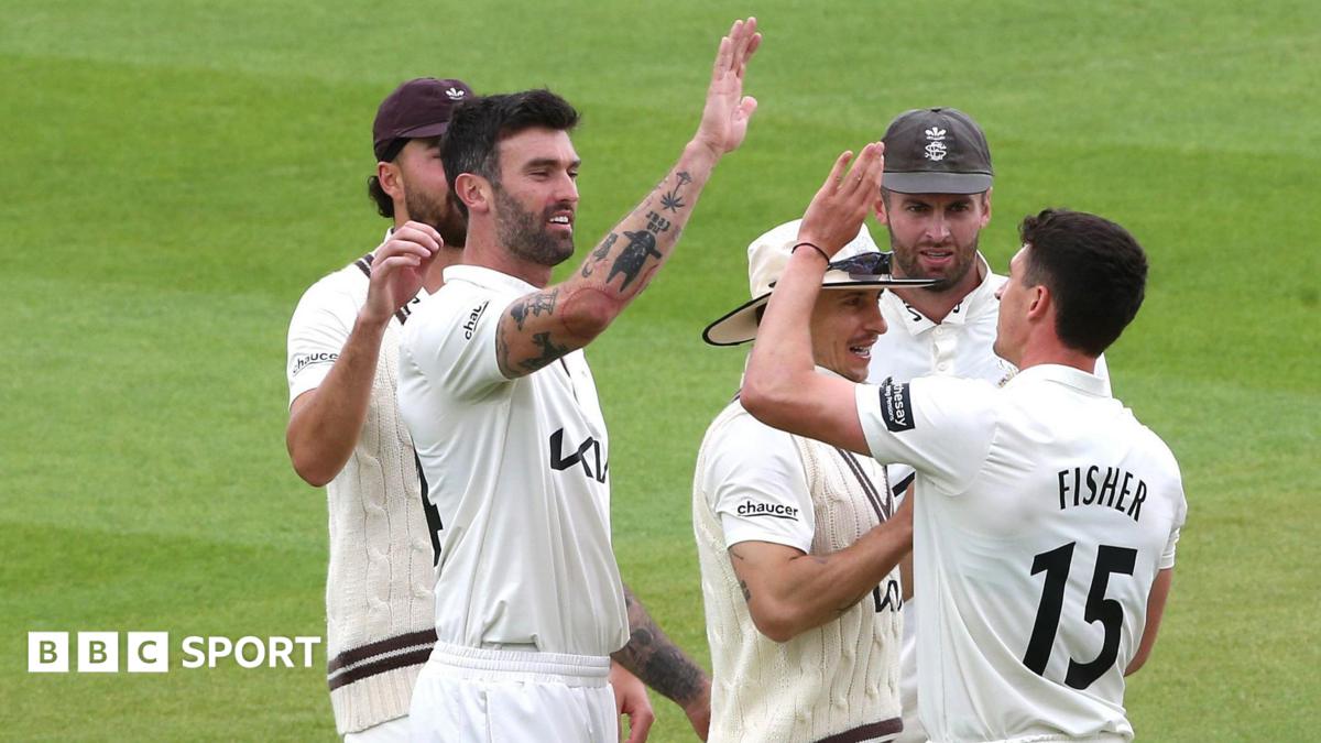 Matt Fisher is congratulated after bowling Toby Albert