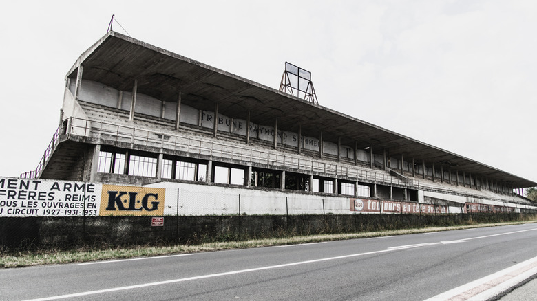 Grandstands sit empty next to a racetrack.
