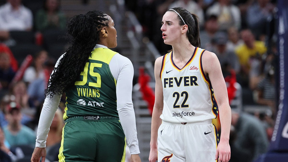 Caitlin Clark and Victoria Vivians exchanging words on basketball court at Gainbridge Fieldhouse