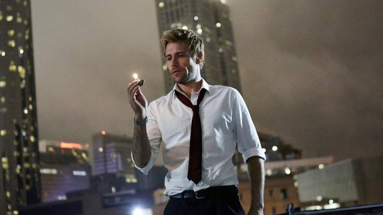John Constantine (Matt Ryan) examines a lighter on a rooftop in Constantine