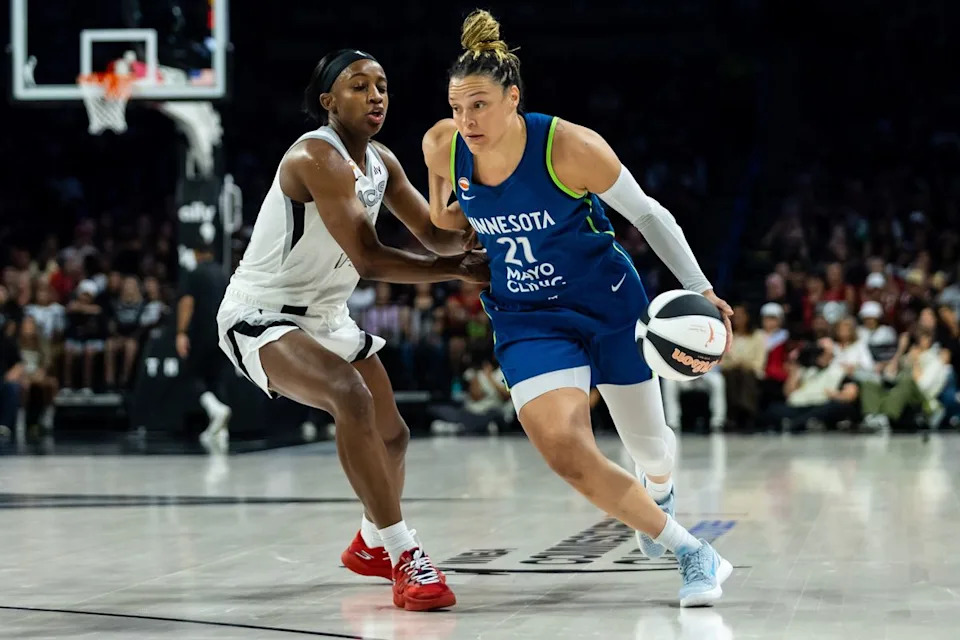 Minnesota Lynx guard Kayla McBride (21) dribbles the ball towards the basket as Las Vegas Aces guard Jackie Young (0) follows her during a WNBA game between the Las Vegas Aces and the Minnesota Lynx, Saturday June 13, 2026 in Las Vegas, Nev.
