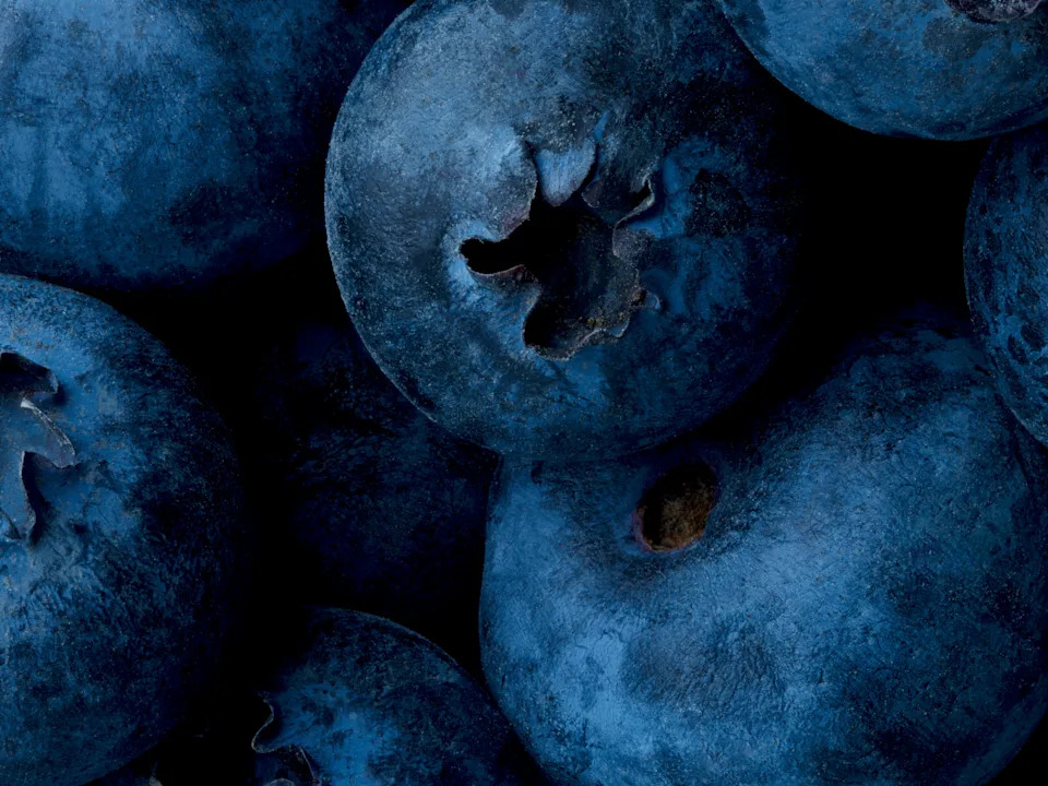 Close-up of fresh blueberries, highlighting their texture and natural patterns