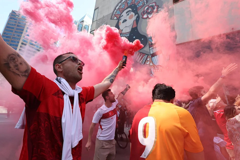 Turkish fans cheer as the team arrives at their hotel in Vancouver, British Columbia, Thursday, June 11, 2026, ahead of the World Cup soccer match between Turkey and Australia. (AP Photo/Emma Peterson)