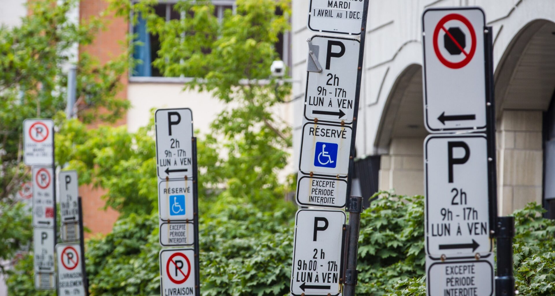 Numerous parking restriction signs are confusing.