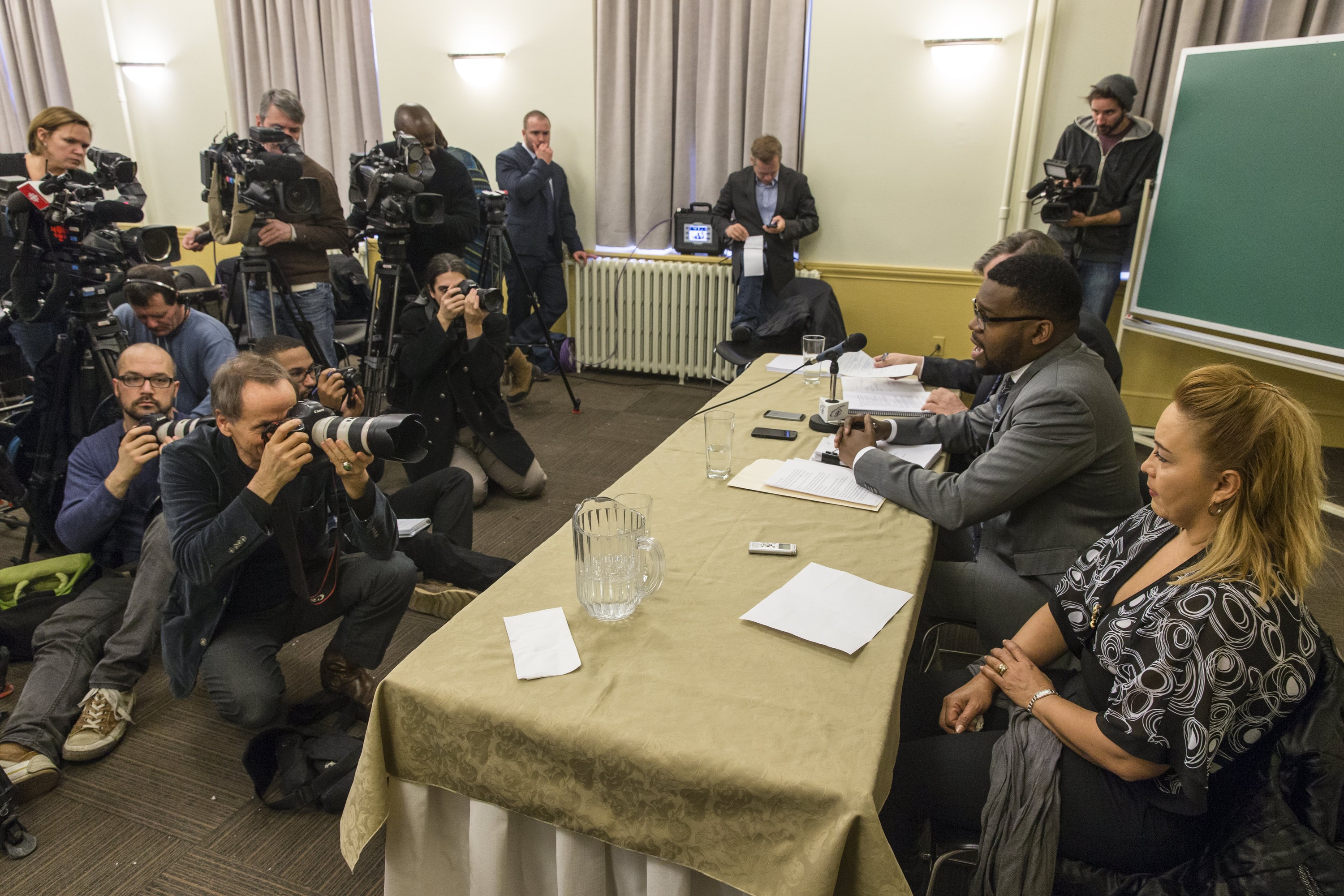 Lilian Villanueva, right, mother of Fredy Villaneuva, who was shot and killed by Montreal police in August 2008, and Villanueva family lawyer Peter Georges-Louis, second from right, speak to the media to react to the Quebec coroner report into the death of Fredy Villanueva in Montreal on Tuesday, December 17, 2013. 