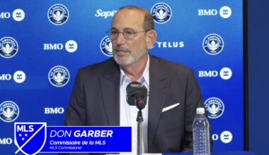 Don Garber speaks while sitting at a desk with a microphone. A graphic superimposed on the image with the MLS logo identifies him. A CF Montréal backdrop is behind.