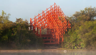 an intricate timber viewpoint by dum-dum lab rises beside chile's laguna troya