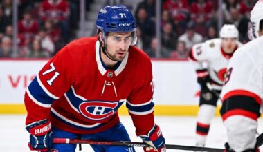 Montreal Canadiens forward Dylan Larkin (number 71) is captured in a red home jersey, skating with the puck in a high-quality NHL action photograph. The photo highlights his focus and skill, a key figure in recent trade speculation.
