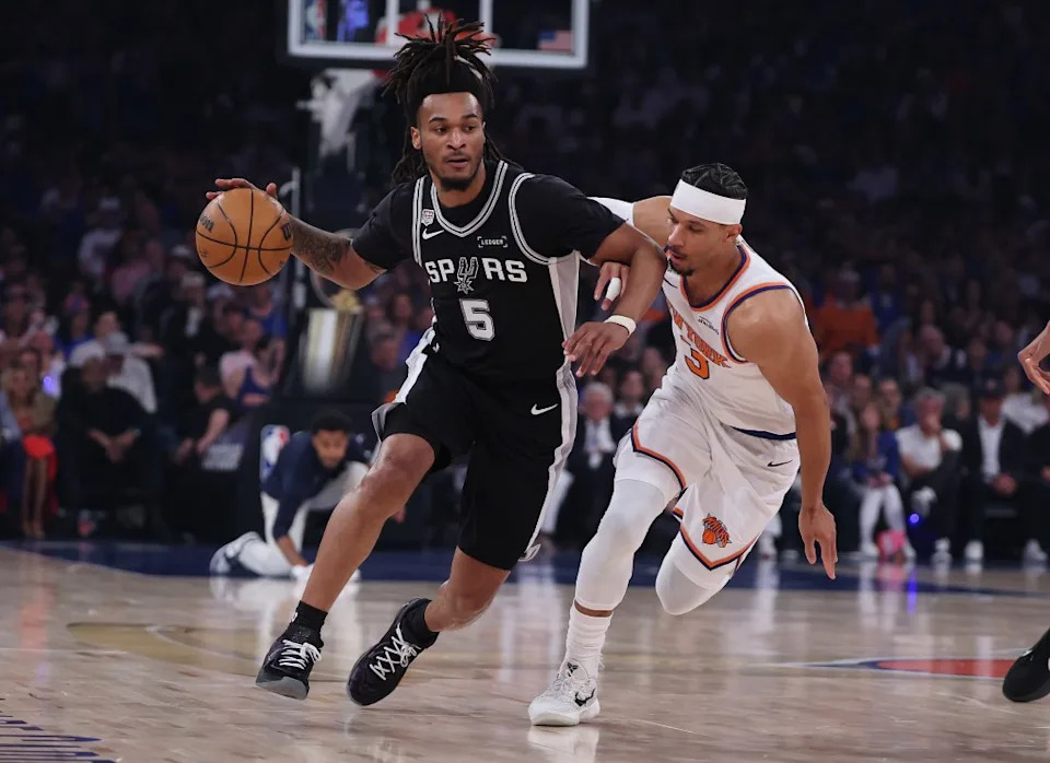 San Antonio Spurs guard Stephon Castle drives past New York Knicks star Josh Hart in NBA Finals game