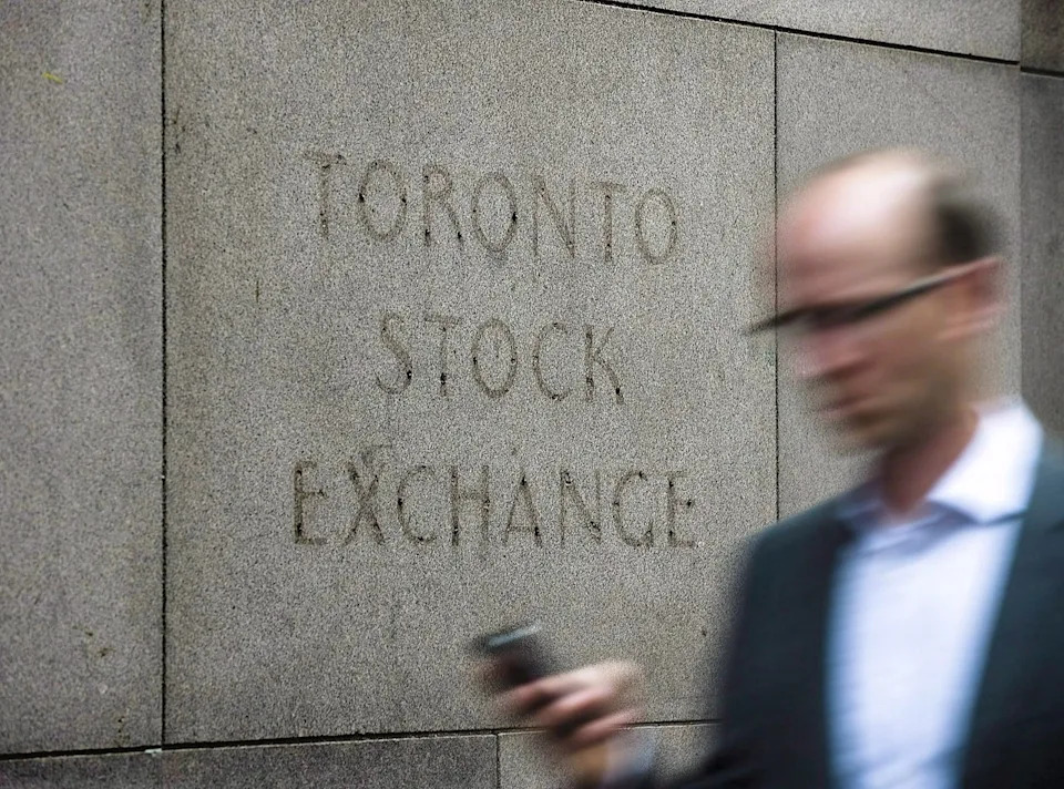A man walks past a building in Toronto that used to house the Toronto Stock Exchange on August 18 2011. THE CANADIAN PRESS/Aaron Vincent Elkaim - The Canadian Press