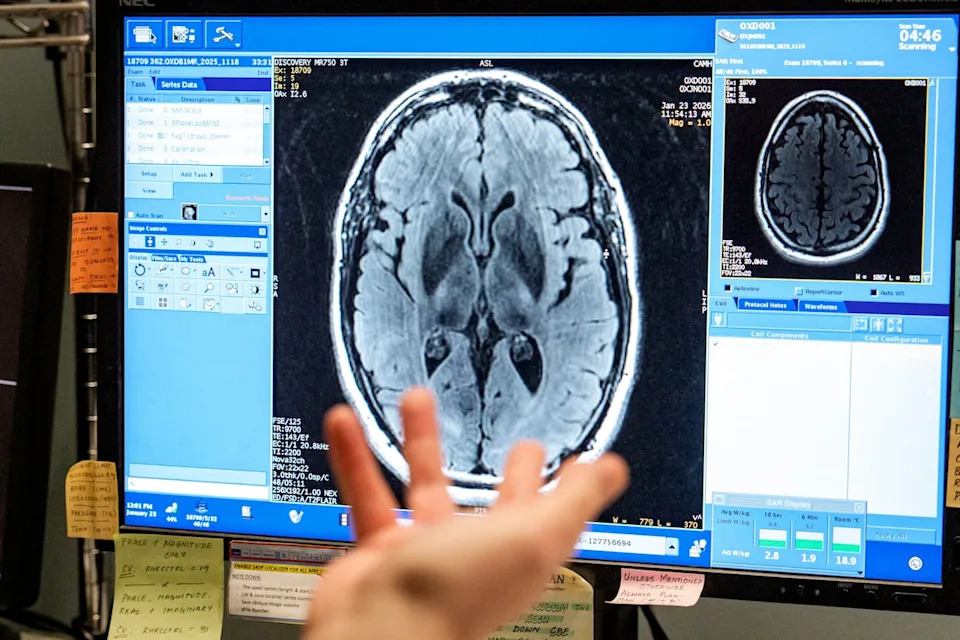 Researchers watch real-time data coming in from an MRI on Brendan Hynes's brain.