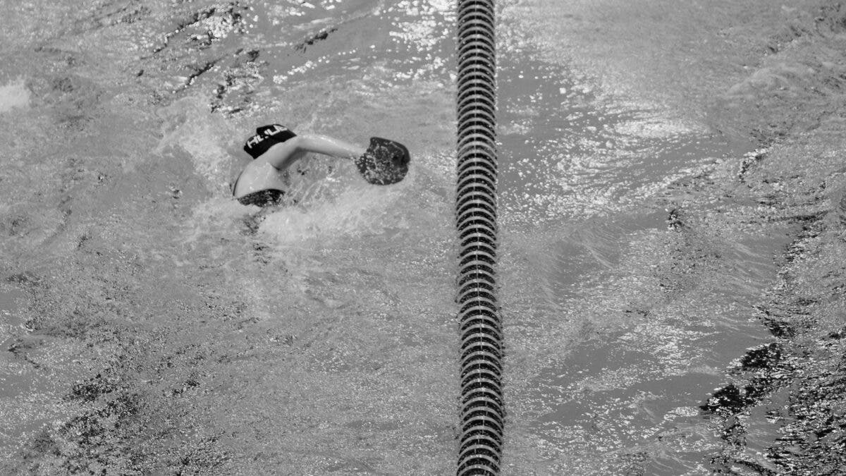 A swimmer swimming along swim lanes.