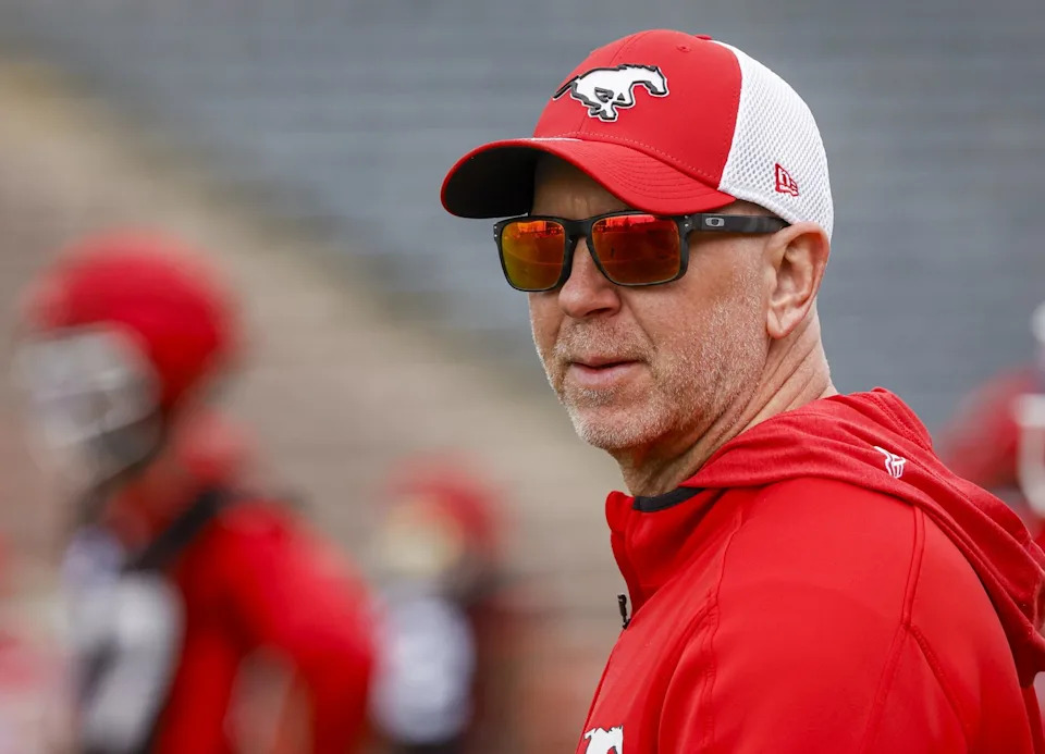 Calgary Stampeders head coach Dave Dickenson, centre, watches drills during opening day of training camp in Calgary, Sunday, May 10, 2026. THE CANADIAN PRESS/Jeff McIntosh