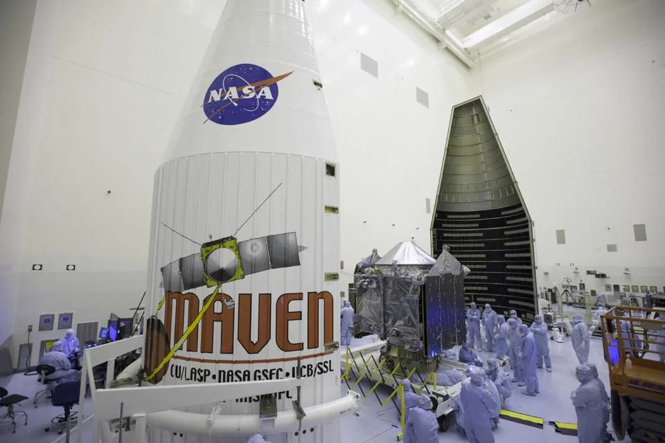 Inside the Payload Hazardous Servicing Facility at NASA's Kennedy Space Center in Florida, engineers and technicians prepare the Mars Atmosphere and Volatile Evolution, or MAVEN, spacecraft for encapsulation inside its payload fairing ca. 2013