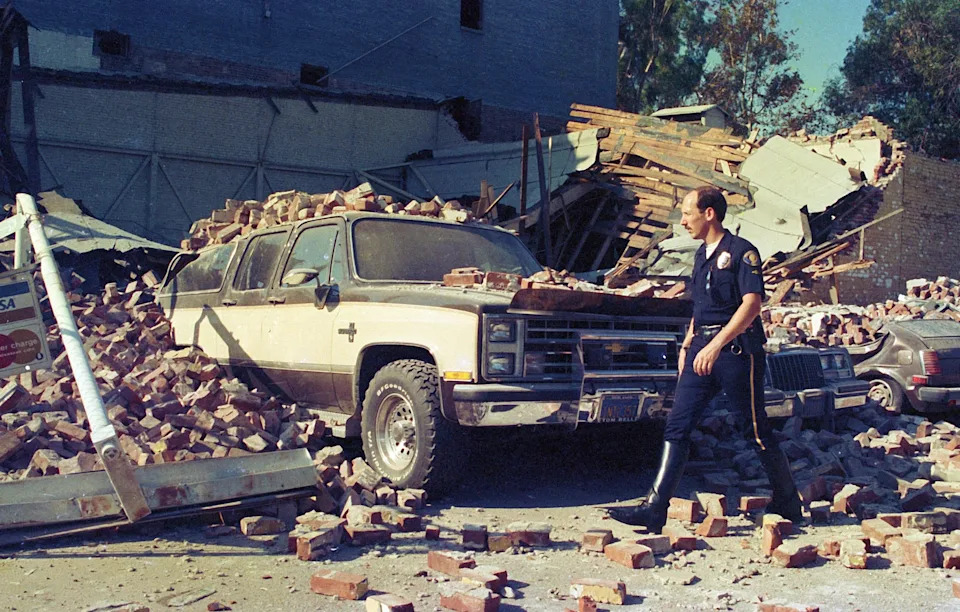 Pasadena police officers inspect damage following an October 1987 earthquake in Southern California. New research suggests stress continues to build along key segments of the San Andreas and San Jacinto fault systems, which have produced at least 36 earthquakes of magnitude 6.4 or greater over the past 1,000 years.