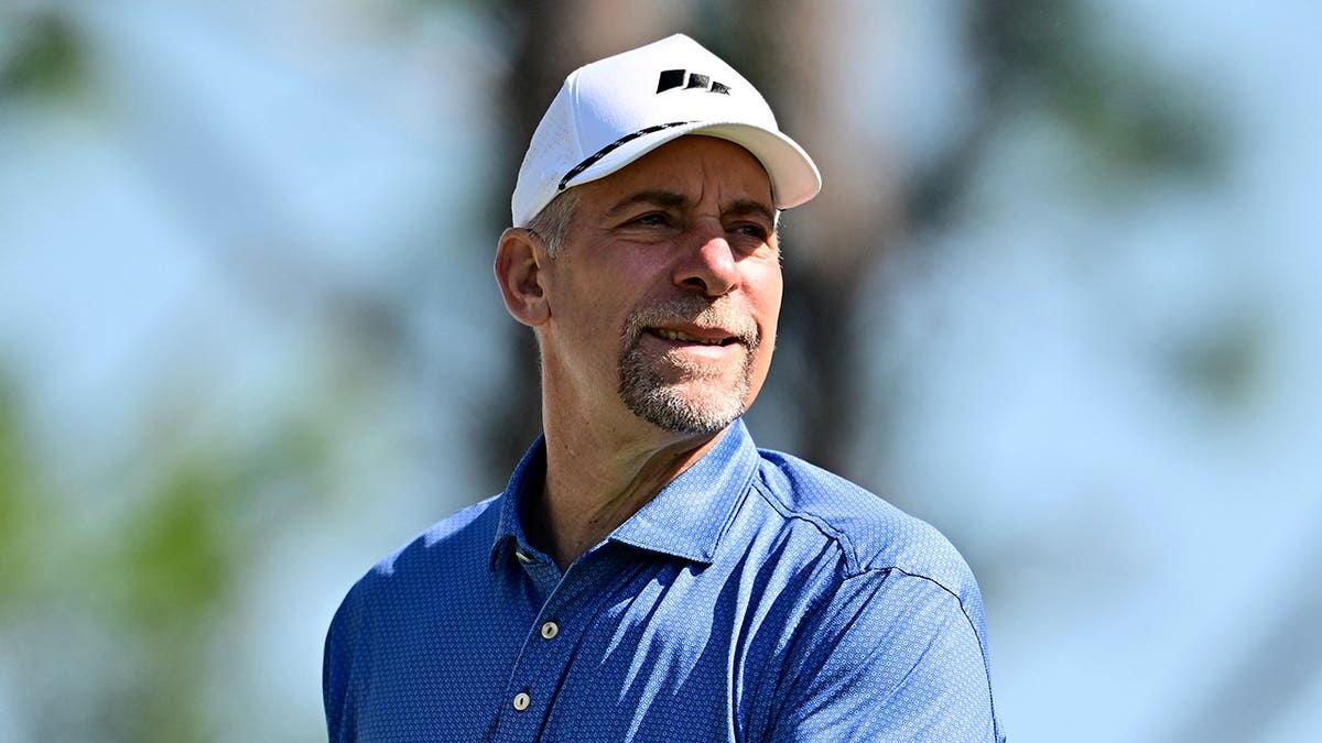 John Smoltz watches his golf shot from the eighth tee at Lake Nona Golf and Country Club