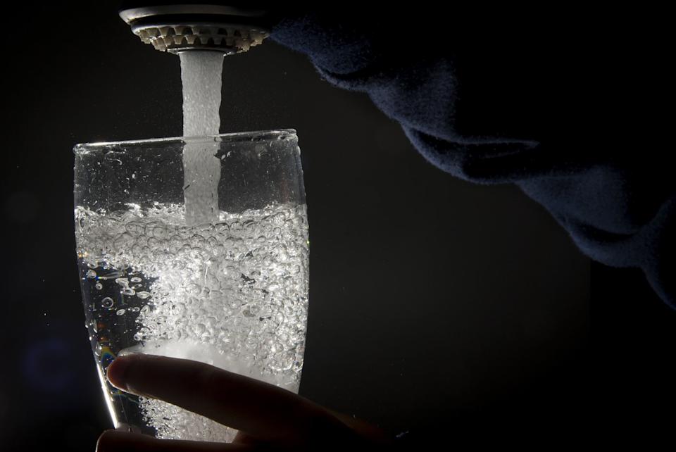 Drinking water is poured into a glass from a faucet in North Vancouver on July, 30, 2019. THE CANADIAN PRESS/Jonathan Hayward - The Canadian Press