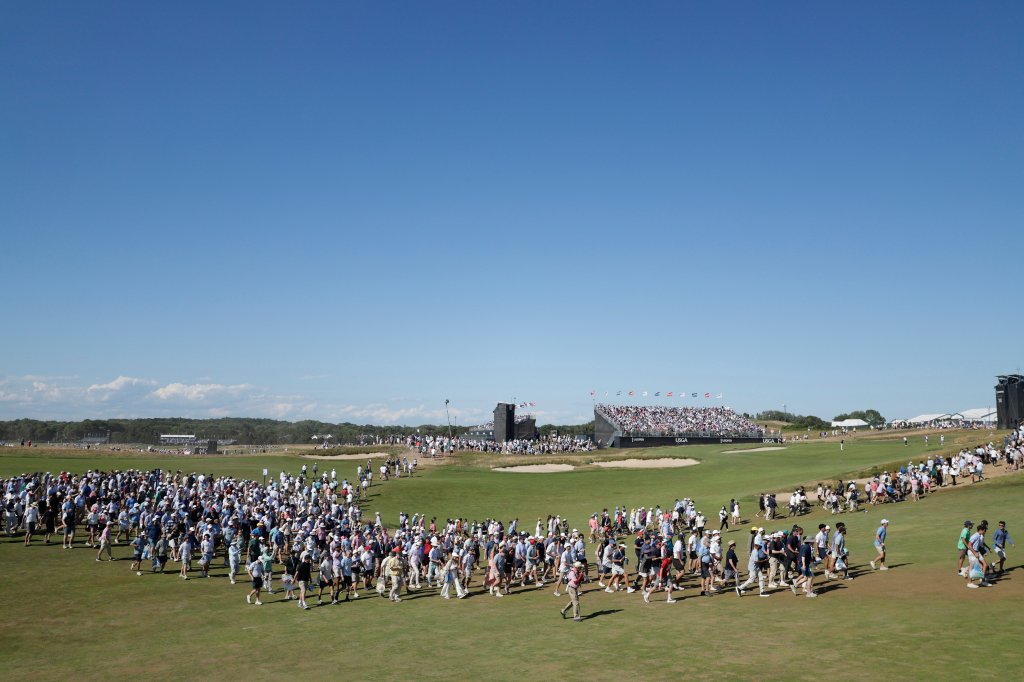 Fans cross the 9th fairway during the final round of the 126th U.S. Open Golf Championship at Shinnecock Hills Golf Club.