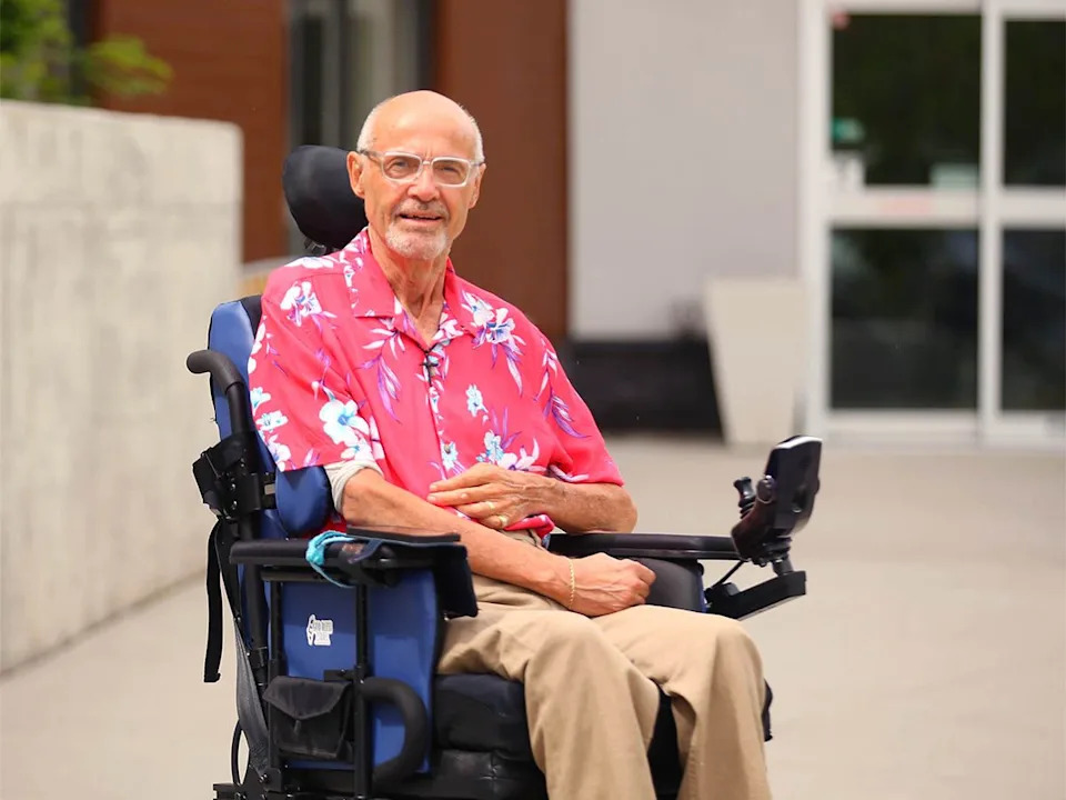 John Karperien, 68, poses in front of Inclusio, an accessible housing location in northwest Calgary on Thursday, June 4, 2026. Karperien has MS and formerly worked as a baker, then attended SAIT for business courses.