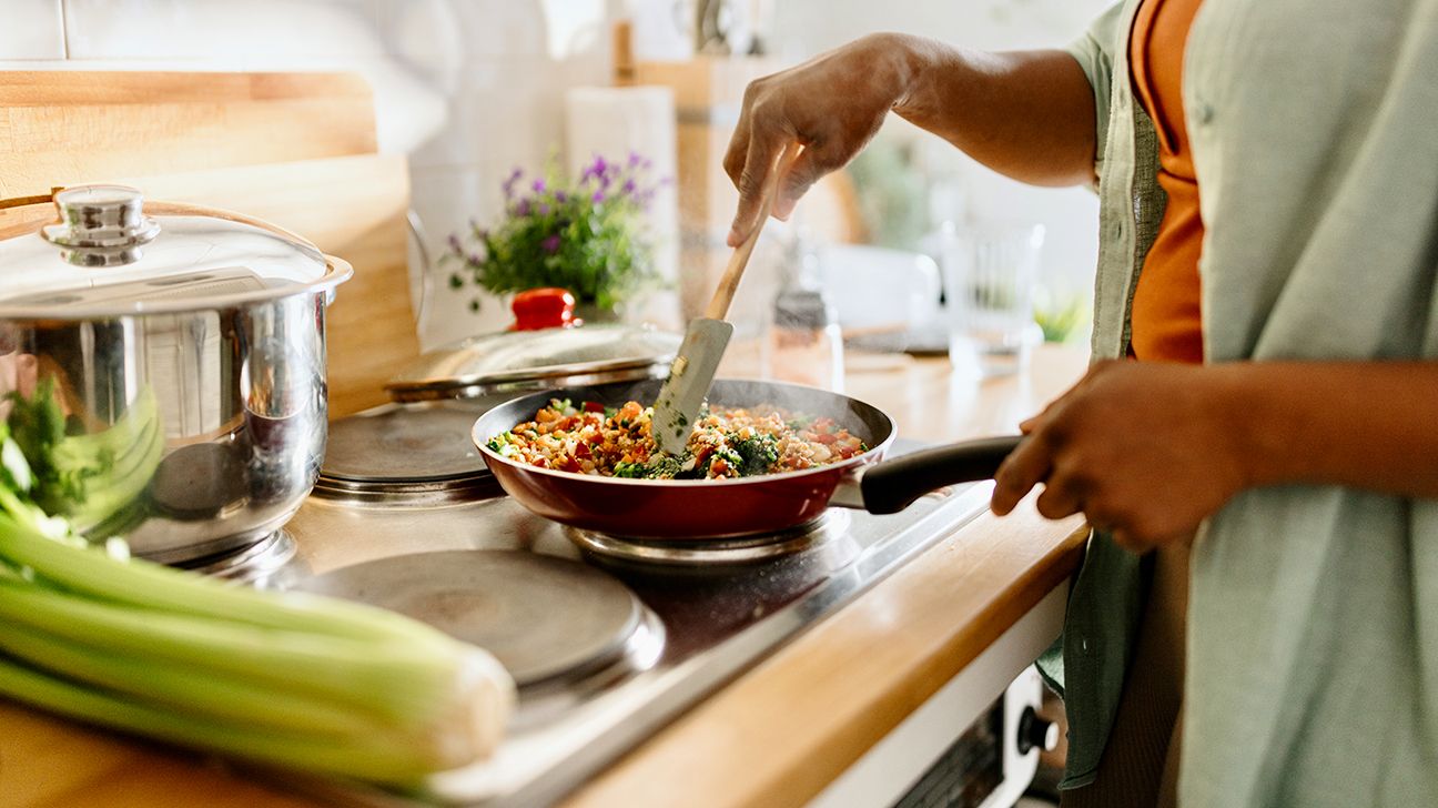 Female cooking at stove