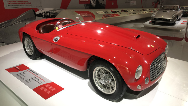 A red Ferrari 166 MM on display