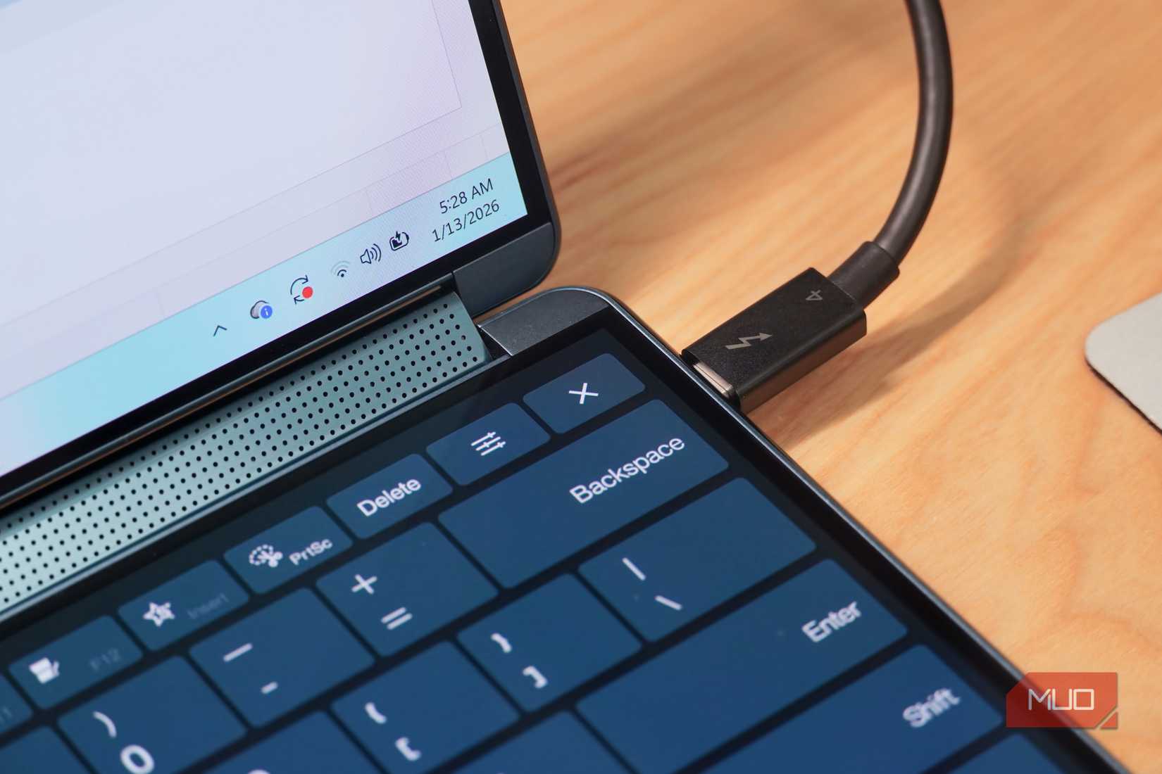 Using a thunderbolt cable to connect a laptop to accessories.