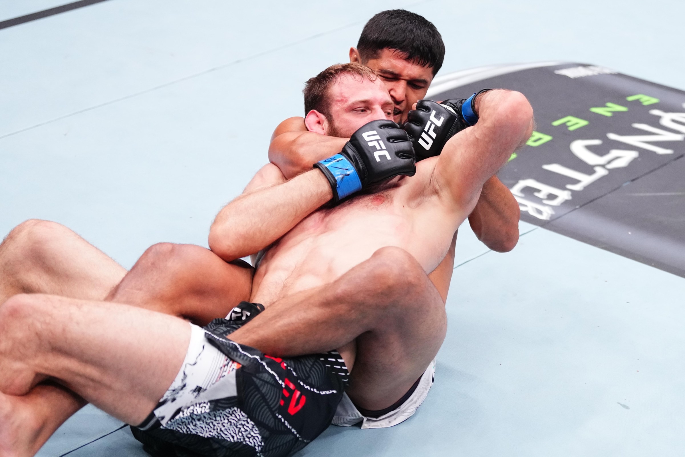 BAKU, AZERBAIJAN - JUNE 27: (R-L) Nursulton Ruziboev of Uzbekistan secures a rear choke submission against Andrey Pulyaev of Russia in a middleweight fight during the UFC Fight Night event at National Gymnastics Arena on June 27, 2026 in Baku, Azerbaijan. (Photo by Jeff Bottari/Zuffa LLC)