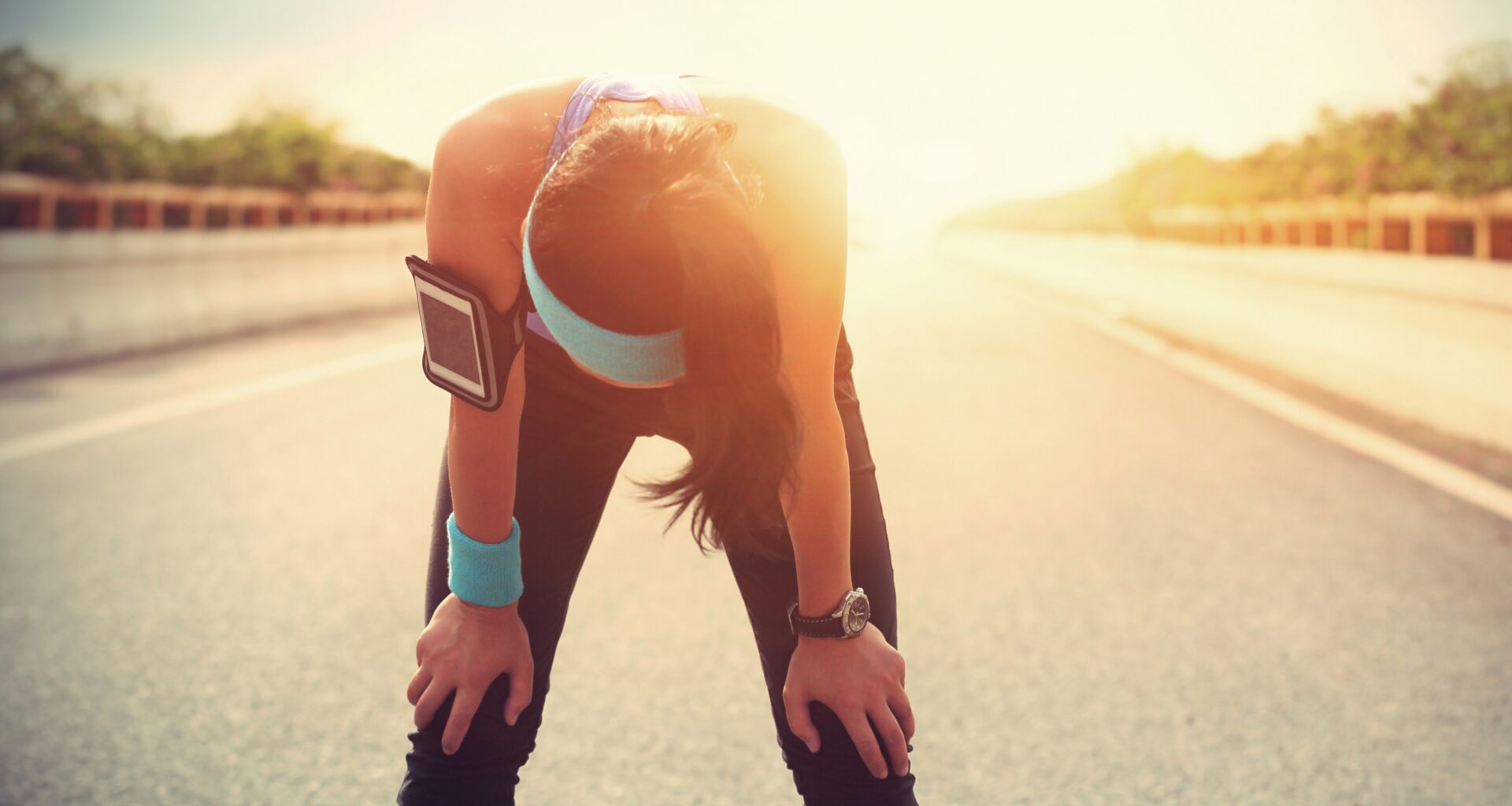 A tired woman runner taking a rest after running hard.
