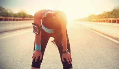 A tired woman runner taking a rest after running hard.