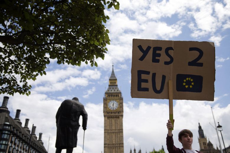 Pictured in front of Big Ben and a statue of former Prime Minister Winston Churchill, a demonstrator protests the outcome of the UK's Brexit referendum in Parliament Square, London, on June 25, 2016.