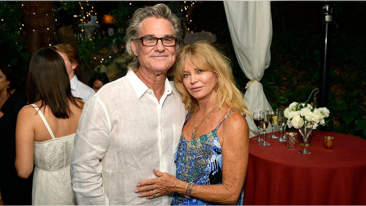 Goldie Hawn and Kurt Russell posing together at an event