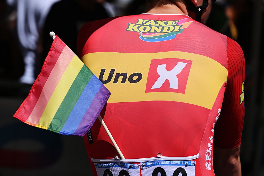 Anders Skaarseth of Norway and Team Uno-X Mobility riders displays an LGBT+ flag prior to the Tour Auvergne-Rhone-Alpes 2026, Stage 8 (Photo by Dario Belingheri/Getty Images)