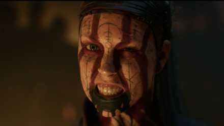Senua grimaces angrily with warpaint on her face in closeup
