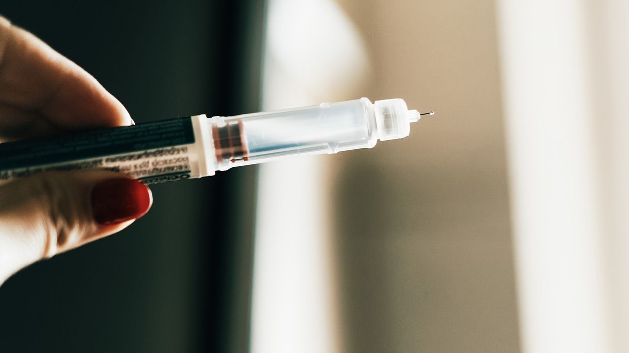 Female hand holding a GLP-1 injection pen