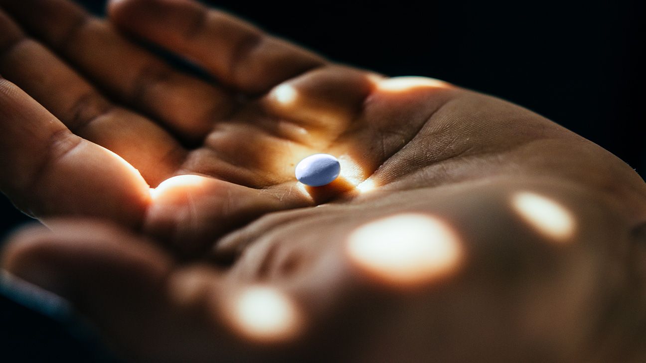 Closeup of blue pill in palmx