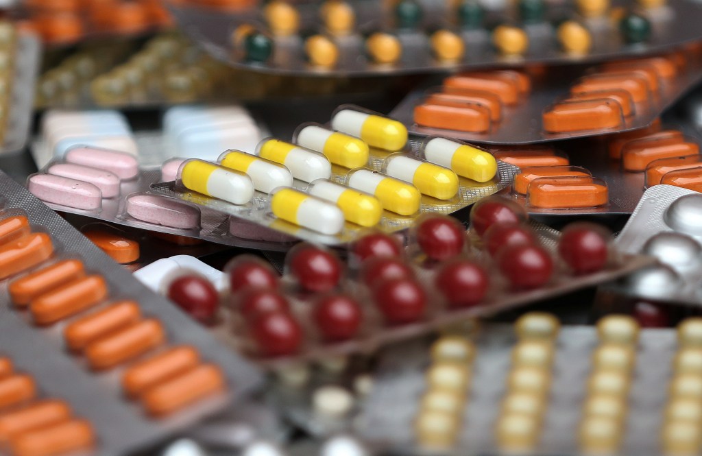 Illustration of various medicine pills in their original packaging.